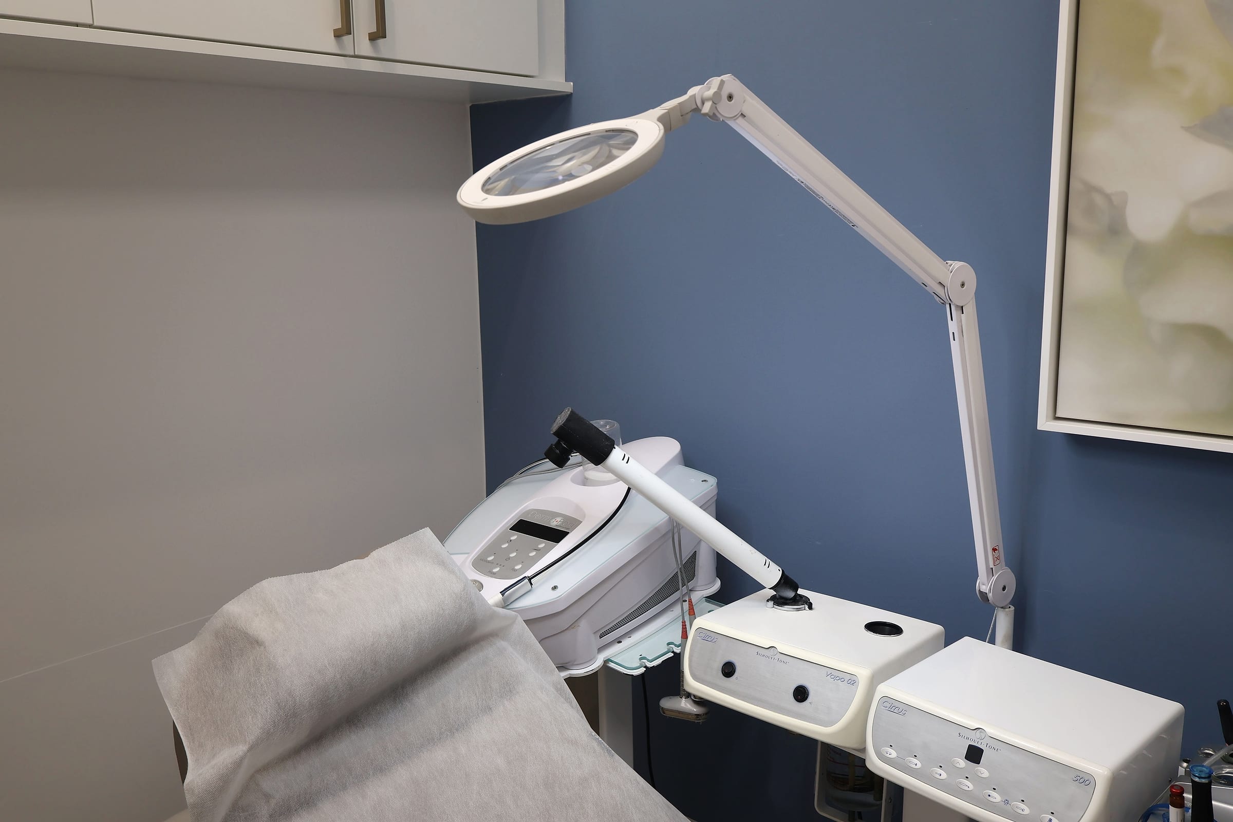 Resurfacing & Regenerative, Skin treatment equipment and magnifying lamp in a Naiva treatment room