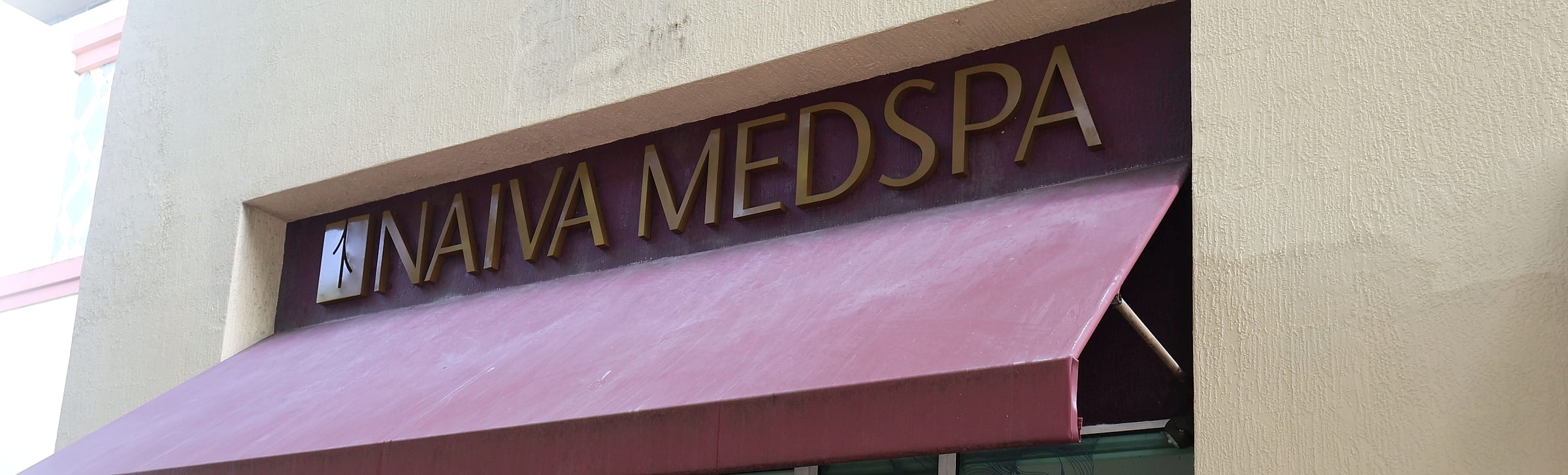 The Naiva Medspa sign and burgundy awning at 3014 Coral Way, Miami